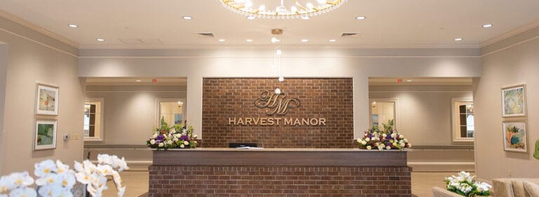 Reception area with floral arrangements and a brick feature wall