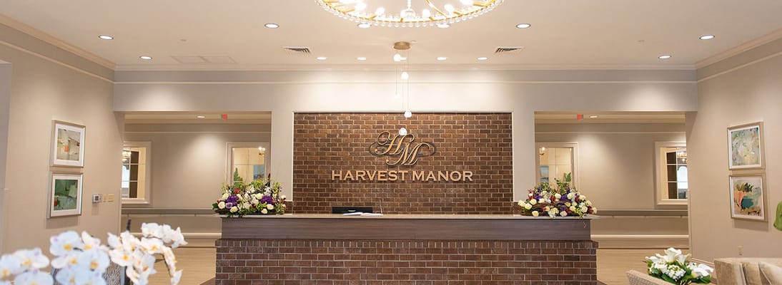 Reception area with floral arrangements and a brick feature wall