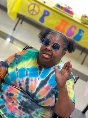 Resident in colorful attire enjoying an activity