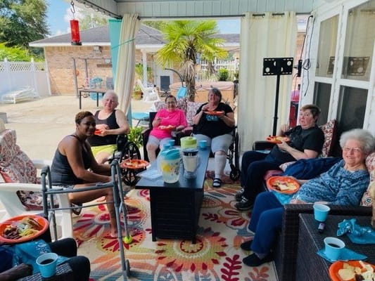 Residents enjoying a meal outside on a sunny day