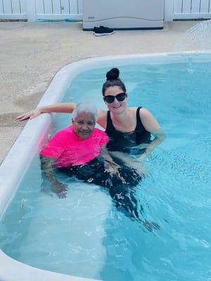 Resident and staff enjoying time in the pool