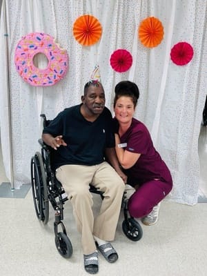 Resident and staff celebrating with decorations