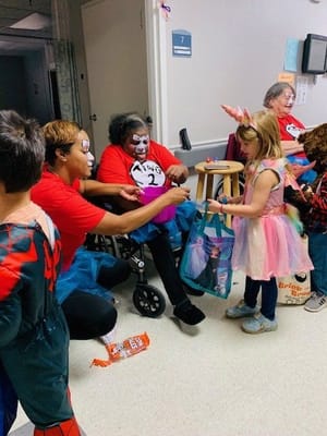 Residents and staff celebrating with costumes during an event