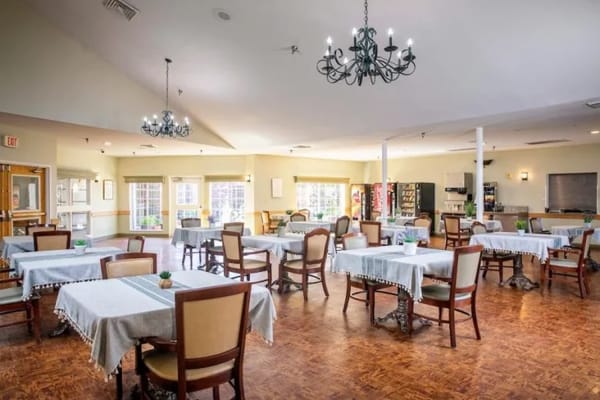 Bright dining room with tables and chairs set up