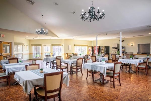 Bright dining room with tables and chairs set up