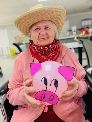 Resident enjoying an activity with a decorated balloon