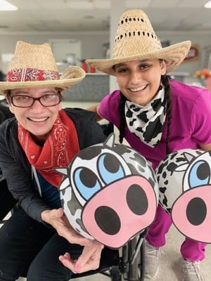 Residents and staff celebrating with playful hats and props