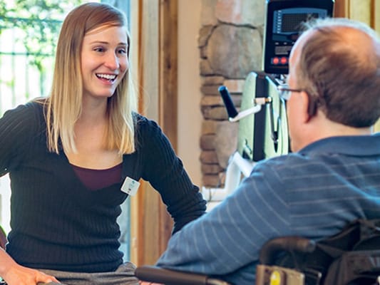 Staff interacting with a resident in an interior setting