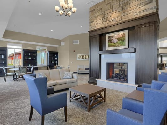 Bright common area with comfortable seating and fireplace