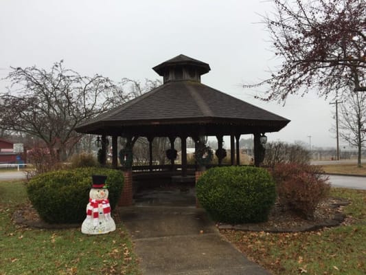 Gazebo in a landscaped garden with a snowman decoration