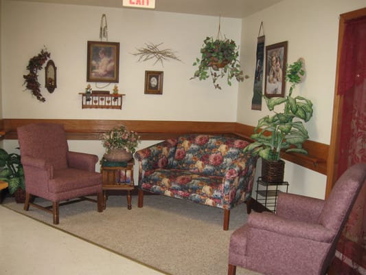 Cozy seating area with floral couch and armchairs