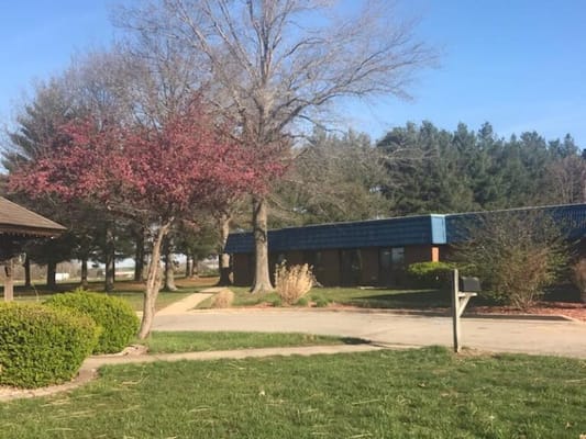 Exterior view of a senior living facility with trees