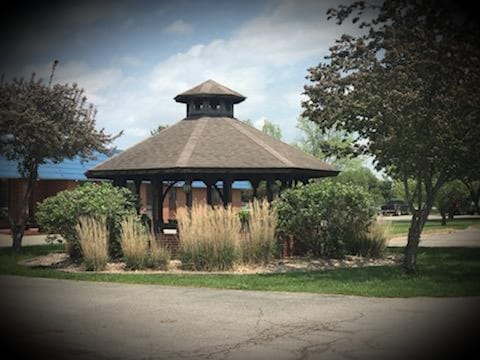 Outdoor gazebo surrounded by greenery