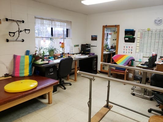 Therapy room with exercise equipment and tables