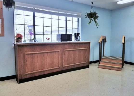 Reception area with a counter and coffee station