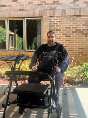 Resident enjoying the outdoor area with a walker