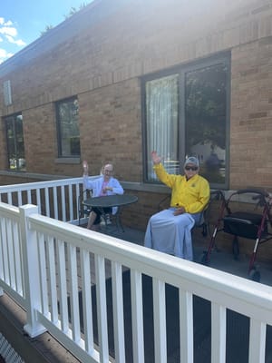 Residents enjoying a sunny day on a patio