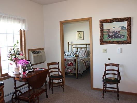 Cozy resident room with a decorated wall and chairs