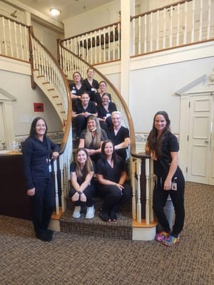 Staff members posing in a beautiful lobby area