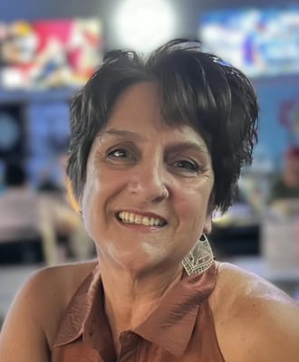 A smiling woman with short hair in a casual setting