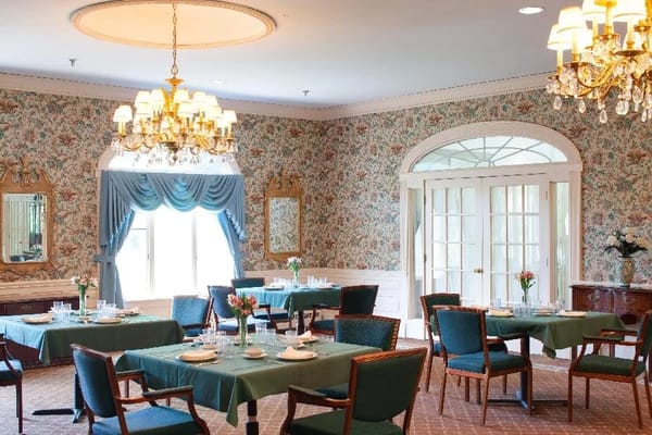 Elegant dining room with floral wallpaper and chandeliers