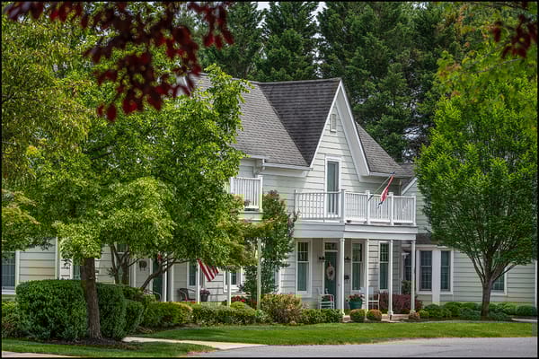 Front view of a residential building surrounded by greenery
