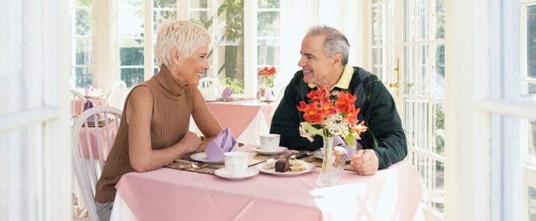 Two residents enjoying a meal together in a dining area
