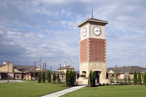 Exterior view of a senior living facility with clock tower