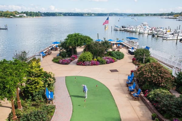 Outdoor activity area with gardens and water view