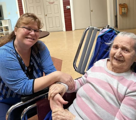A staff member engaging with a resident in a common area