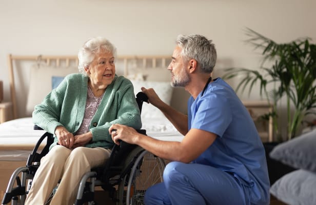 Nurse interacting with a senior resident in a cozy room