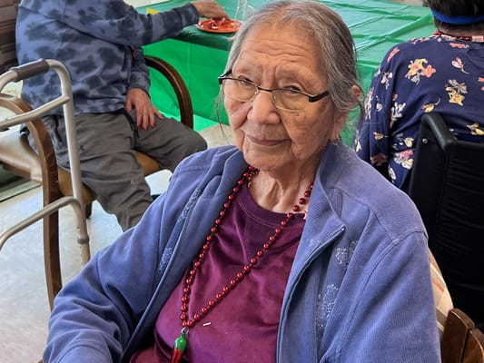 Resident smiling in a common area with decorations