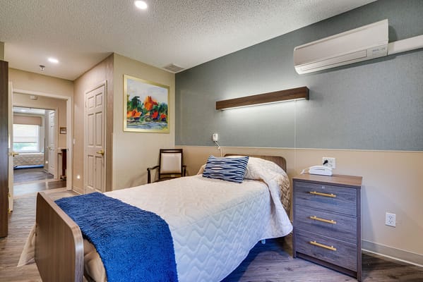 Cozy resident room with a bed and artwork