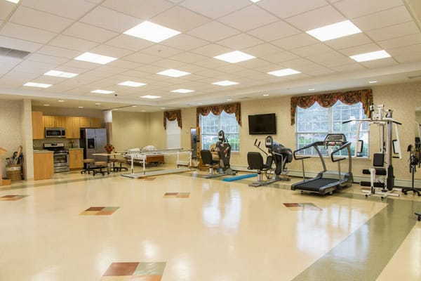 Interior fitness area with exercise equipment and seating