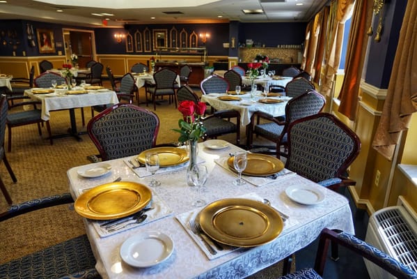 Elegant dining room setup with tables and flowers