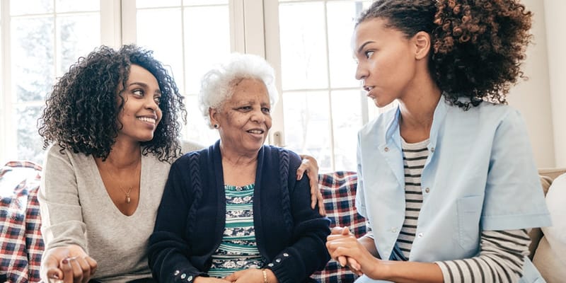 A caregiver interacting warmly with a senior resident
