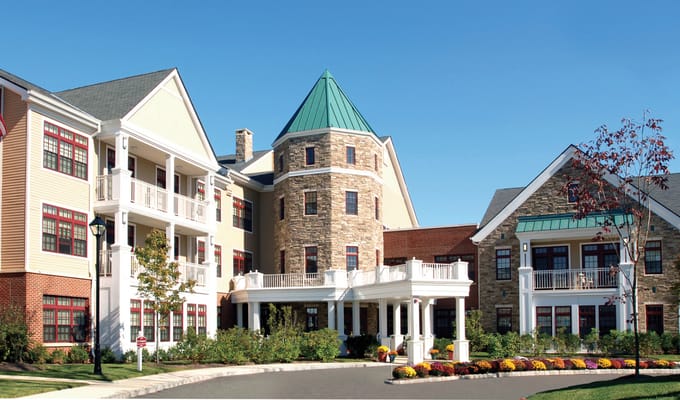 Exterior view of a senior living facility with gardens
