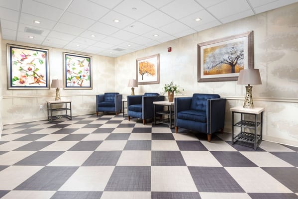 Bright common area with stylish blue chairs and artwork