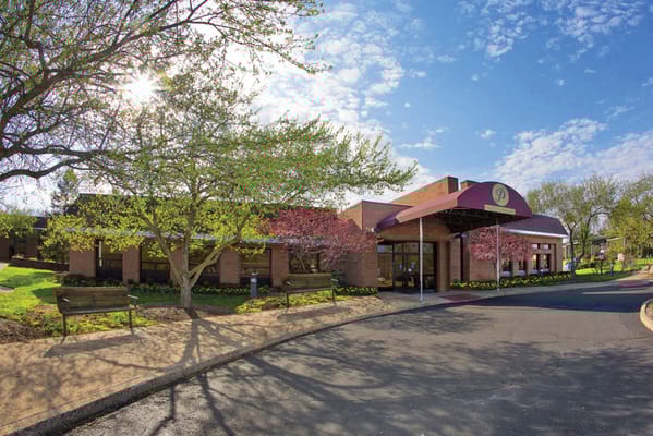 Front entrance of a senior living facility on a sunny day