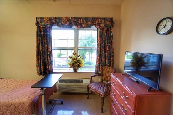 Cozy resident room with a window and furnishings