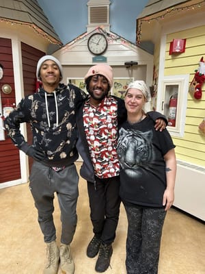 Staff members posing in a decorated common area