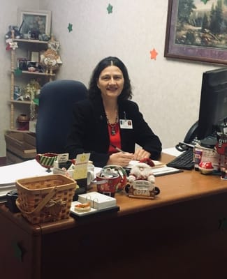 Staff member at a desk in a brightly decorated office