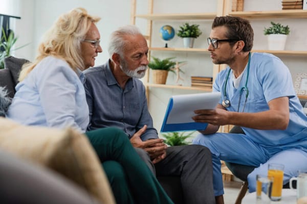 Healthcare professional discussing with seniors in a cozy setting