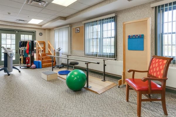 Rehabilitation exercise area with equipment and a chair