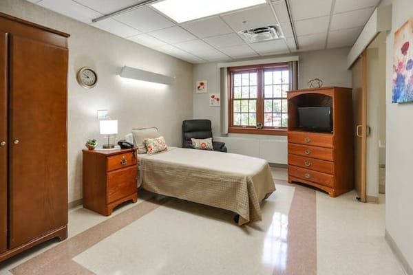 Comfortable resident room with a bed and furniture