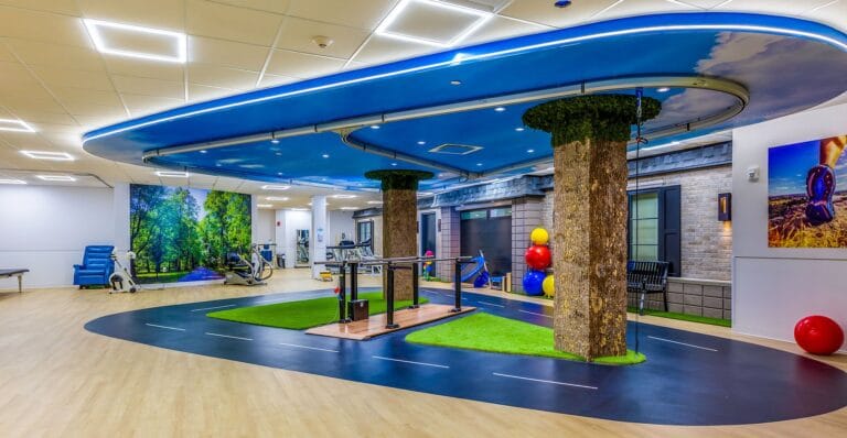 Modern therapy room with trees and exercise equipment