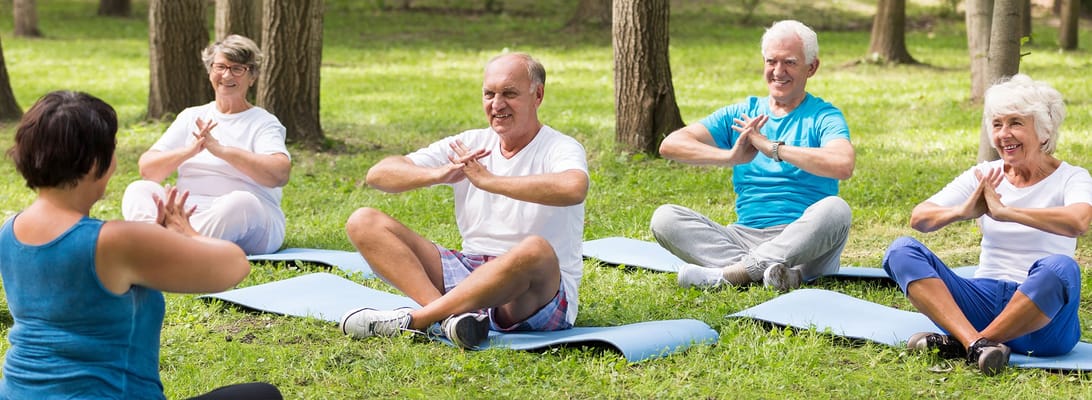 Seniors participating in an outdoor yoga class