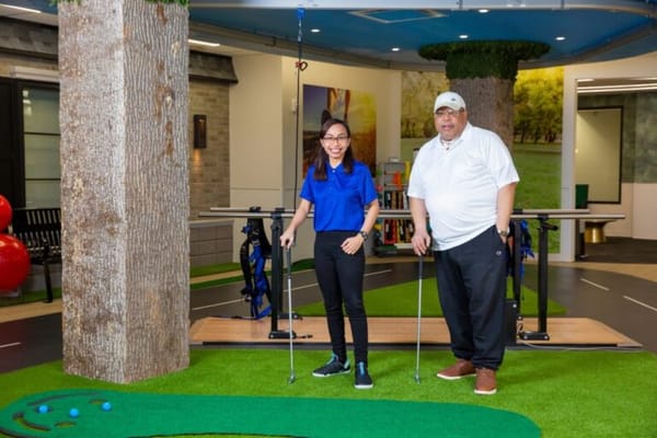 Residents engaging in indoor putting practice