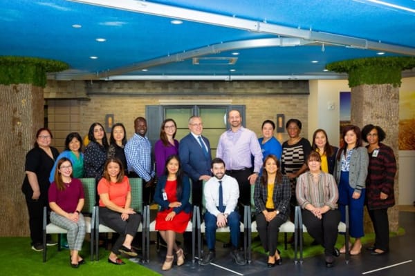 Staff members posing in a modern common area