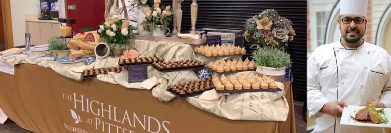 Chef presenting a plate of gourmet food at a dining event